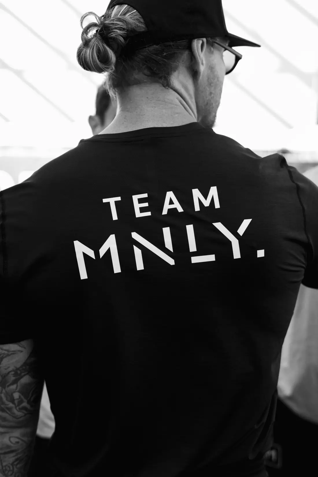 Athlete wearing a Team MNLY shirt at a HYROX event