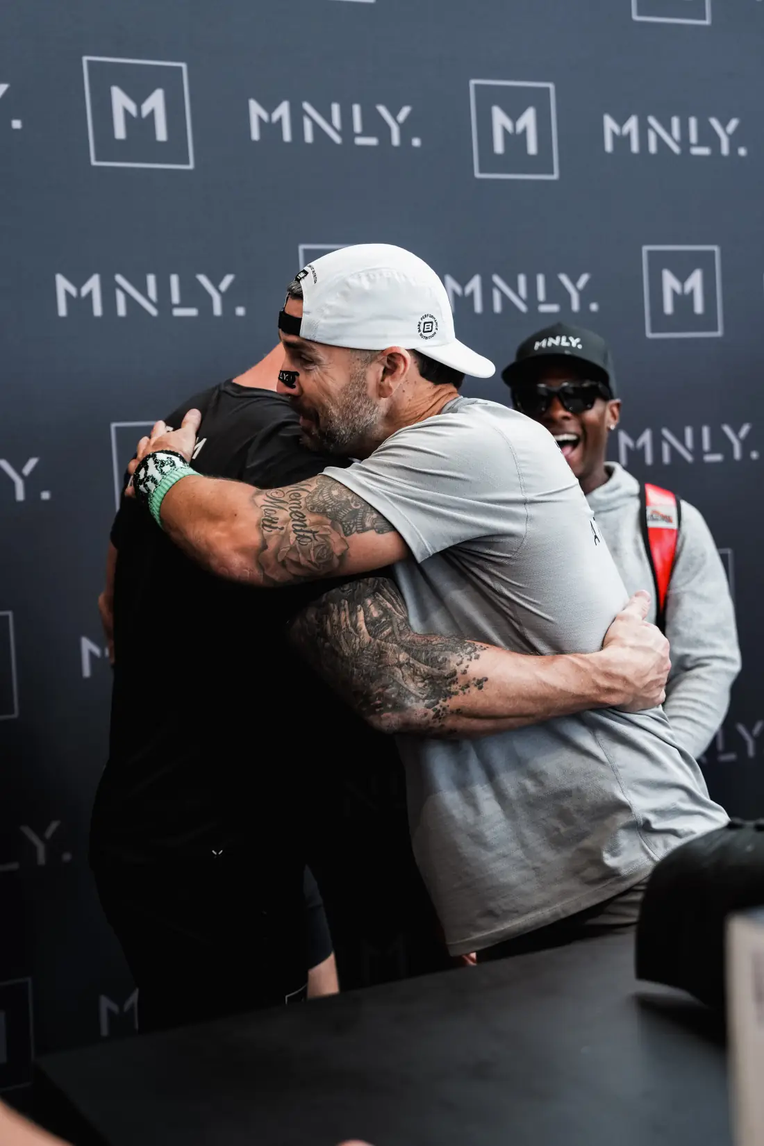 Team MNLY athletes celebrating at the MNLY booth