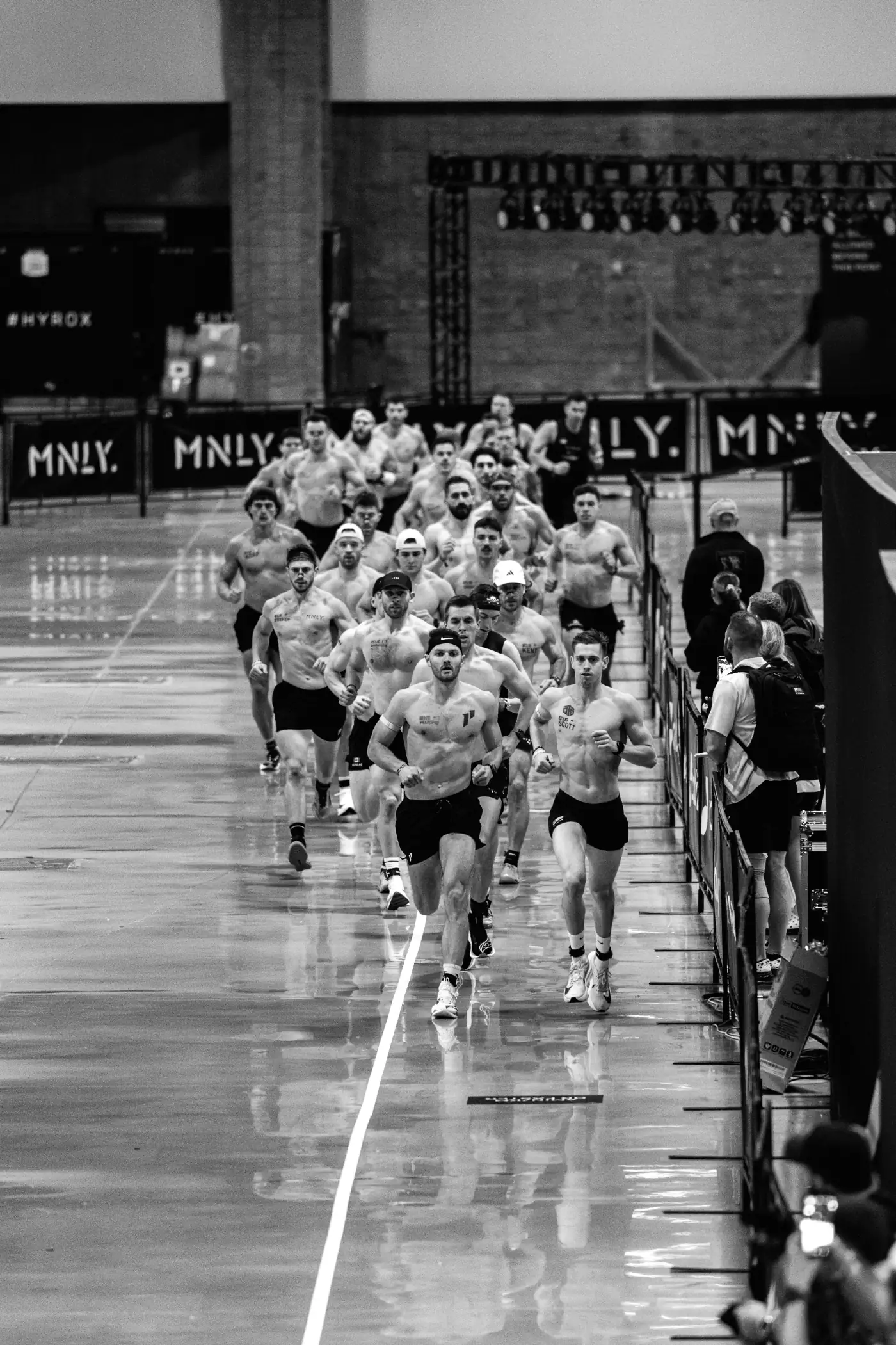 Team MNLY athletes lined up at a HYROX start corral